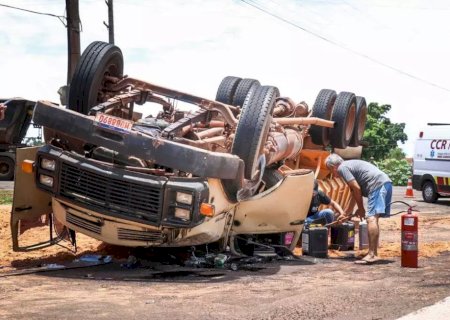 Caminhão tomba, cabine fica destruída e carga atinge mãe e filha.